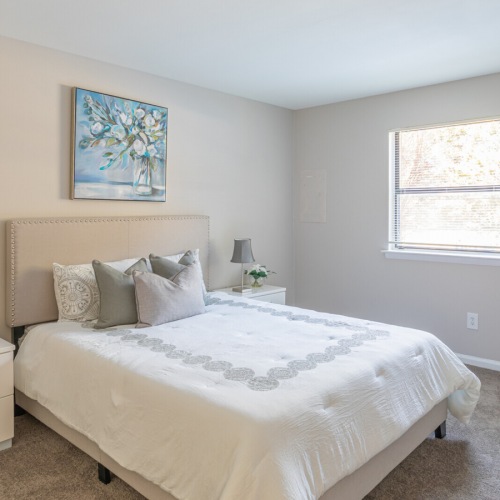 Bedroom with natural lighting and plush carpet