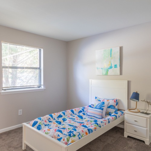 Bedroom with natural lighting and plush carpet